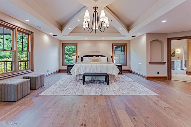 bedroom featuring hardwood / wood-style floors and an inviting chandelier