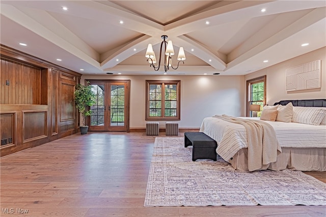 bedroom featuring an inviting chandelier, hardwood / wood-style floors, french doors, and access to exterior