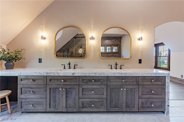 bathroom featuring vanity and vaulted ceiling