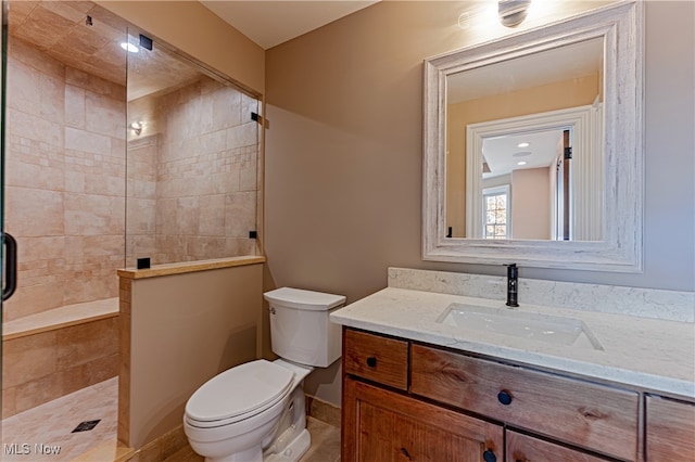 bathroom featuring an enclosed shower, vanity, and toilet