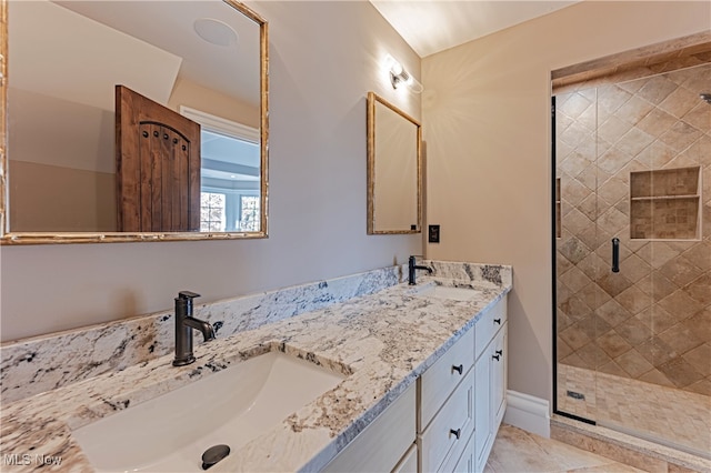 bathroom featuring an enclosed shower, vanity, and tile patterned floors