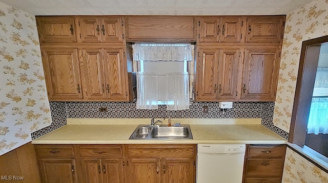 kitchen with backsplash, dishwasher, and sink