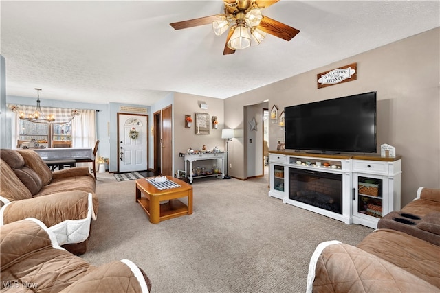 living room featuring carpet, a textured ceiling, and ceiling fan with notable chandelier