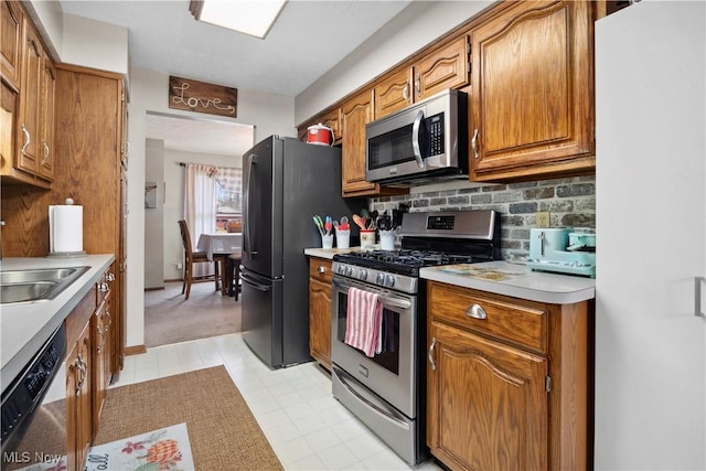 1284 Laurel Dr, West Salem, OH 44287 - kitchen featuring appliances with stainless steel finishes, light countertops, backsplash, and brown cabinets