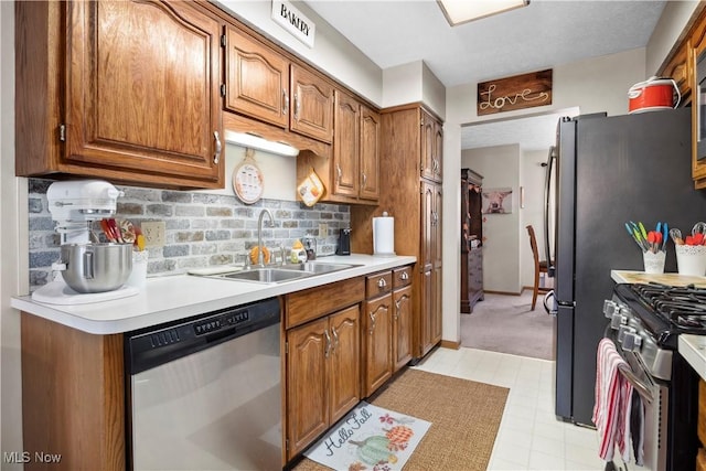 1284 Laurel Dr, West Salem, OH 44287 - kitchen featuring appliances with stainless steel finishes, a sink, brown cabinetry, and backsplash