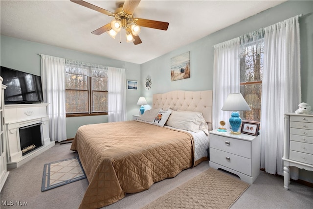 bedroom featuring light colored carpet and ceiling fan