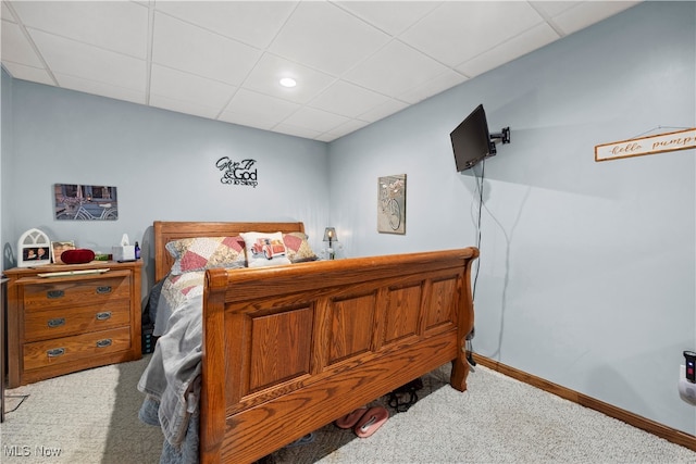 bedroom with a drop ceiling and carpet floors