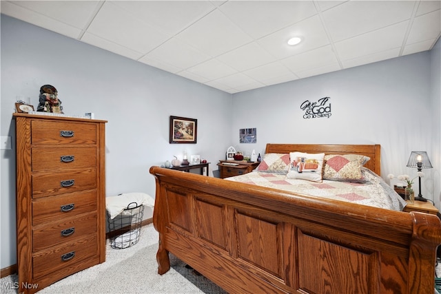 carpeted bedroom with a drop ceiling