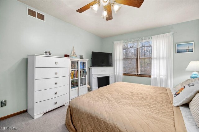1284 Laurel Dr, West Salem, OH 44287 - carpeted bedroom with baseboards, a fireplace, and a ceiling fan