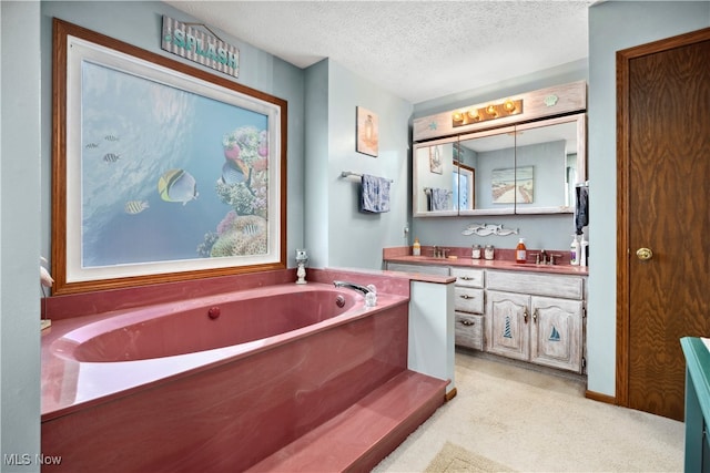 bathroom featuring a bath, a textured ceiling, and vanity