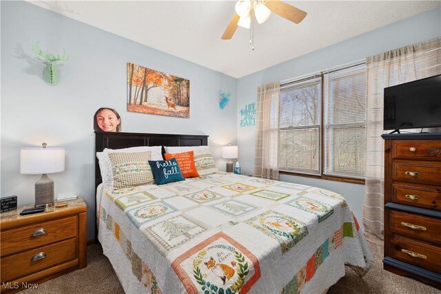 bedroom featuring ceiling fan and carpet floors