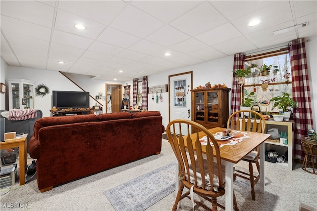 dining room with carpet flooring and a drop ceiling