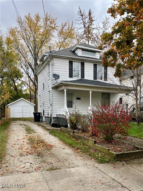 view of front of house featuring covered porch and a storage shed