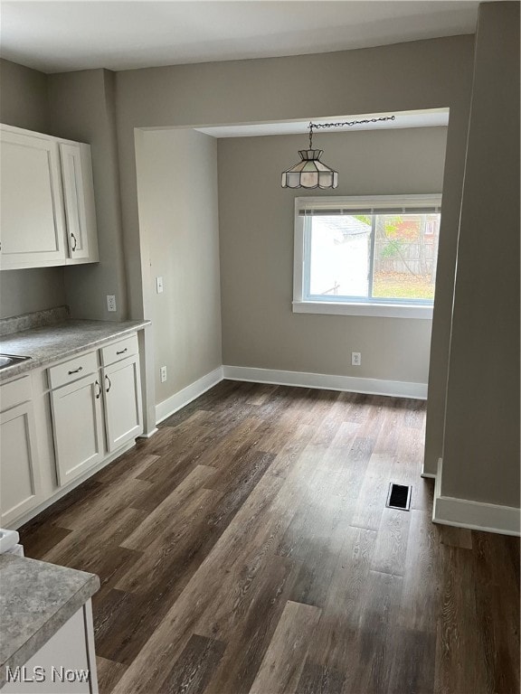 unfurnished dining area with dark hardwood / wood-style floors