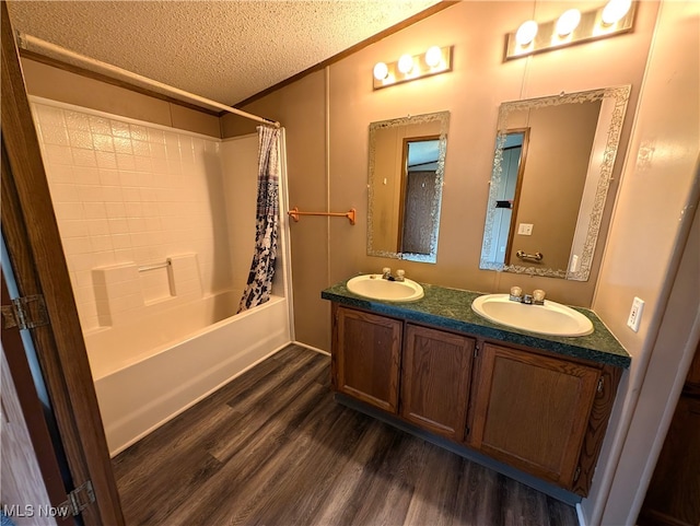 bathroom featuring ornamental molding, vanity, a textured ceiling, hardwood / wood-style floors, and shower / bathtub combination with curtain