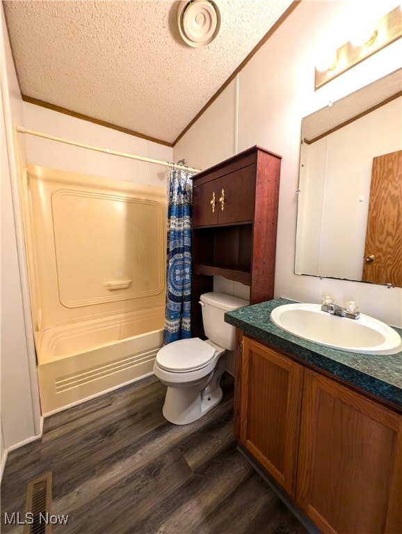 full bathroom featuring vanity, a textured ceiling, shower / bath combo, hardwood / wood-style floors, and vaulted ceiling