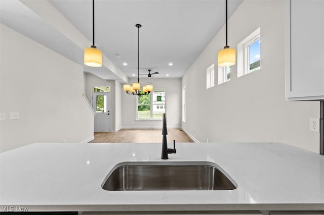 kitchen with pendant lighting, sink, and a healthy amount of sunlight