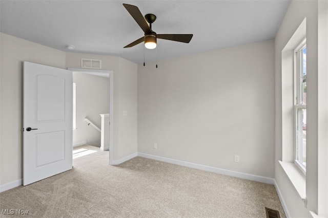 unfurnished bedroom with light colored carpet and ceiling fan