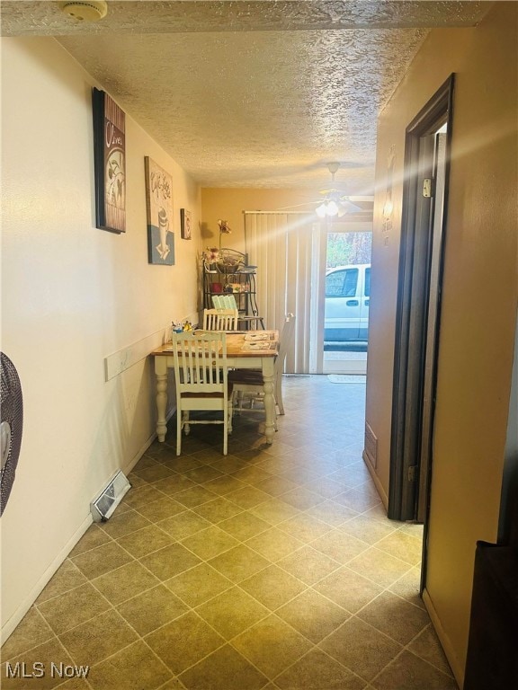 corridor featuring a textured ceiling