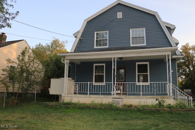 view of front of house with a porch and a front yard