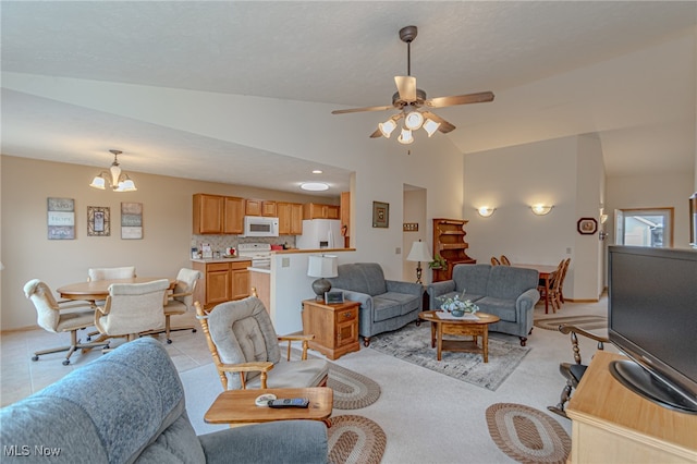 living room with ceiling fan with notable chandelier, lofted ceiling, and light tile patterned flooring