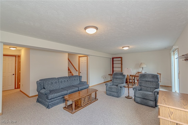 living room featuring carpet flooring and a textured ceiling