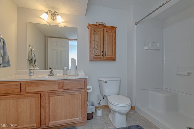 bathroom with toilet, tile patterned flooring, a textured ceiling, vanity, and a shower