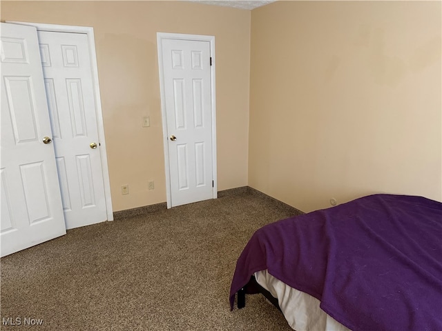 bedroom featuring dark carpet