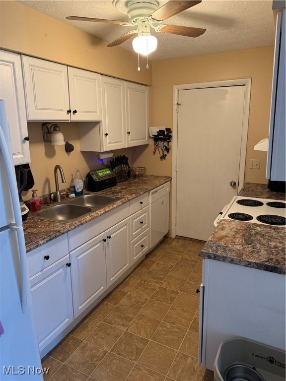 kitchen featuring white cabinetry, a textured ceiling, sink, white appliances, and ceiling fan