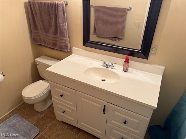 bathroom featuring tile patterned flooring, vanity, and toilet