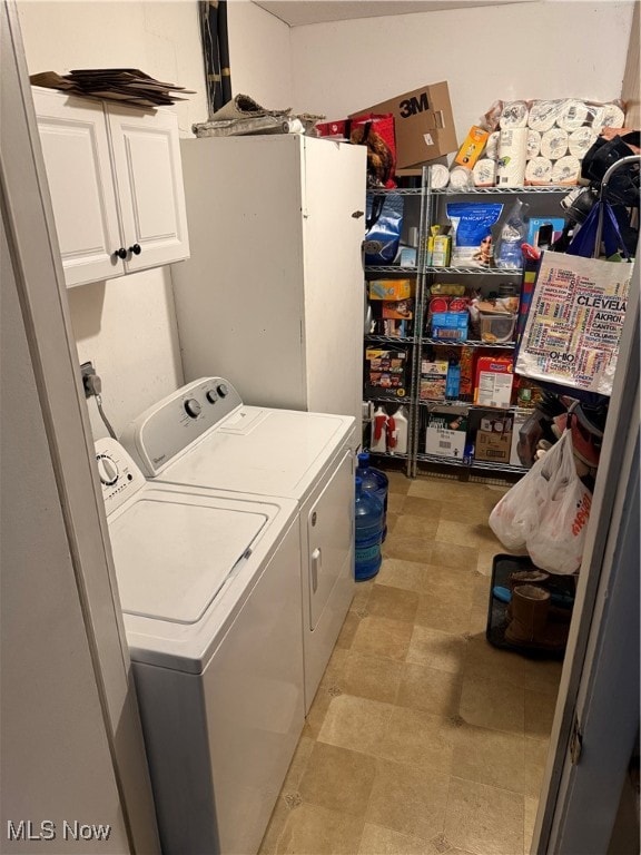 laundry area with cabinets and washing machine and dryer