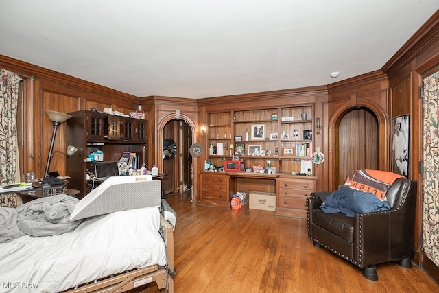 bedroom featuring ornamental molding and wood-type flooring