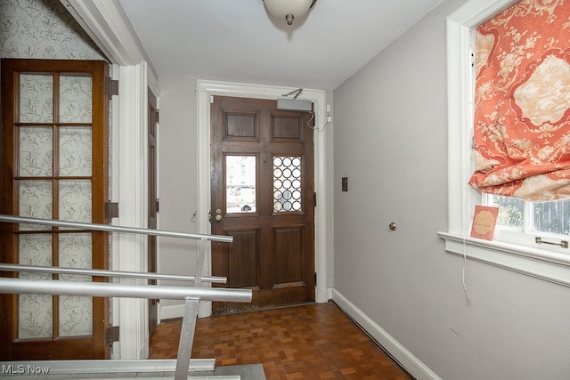 foyer featuring dark parquet flooring