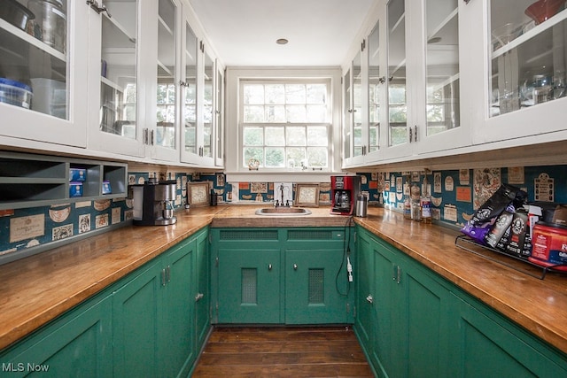 bar with butcher block counters, dark wood-type flooring, and green cabinetry