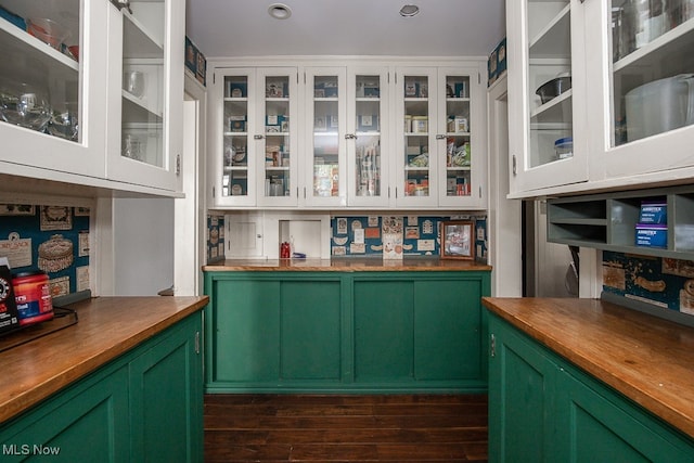 bar featuring butcher block countertops, white cabinetry, green cabinetry, and dark hardwood / wood-style floors