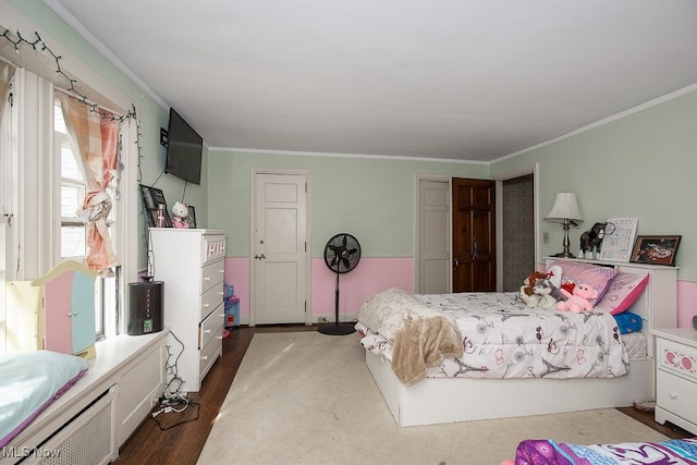 bedroom with dark hardwood / wood-style flooring and crown molding