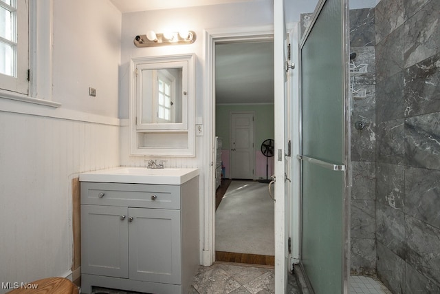 bathroom featuring vanity and tiled shower