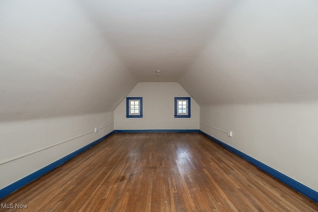 bonus room featuring dark hardwood / wood-style floors and lofted ceiling