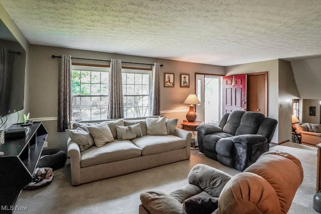 carpeted living room featuring a textured ceiling