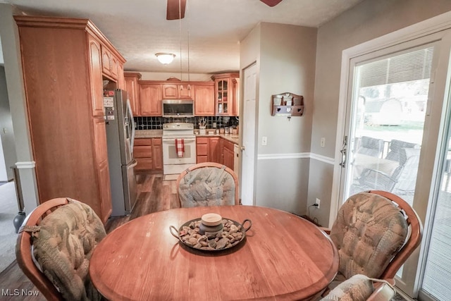 dining room with ceiling fan and dark hardwood / wood-style floors