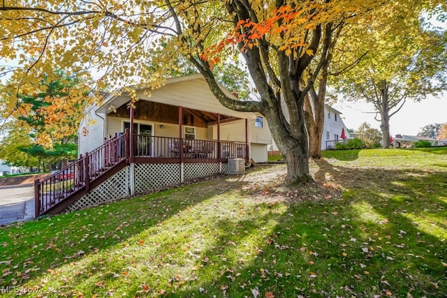 view of front of property with a front yard and a deck