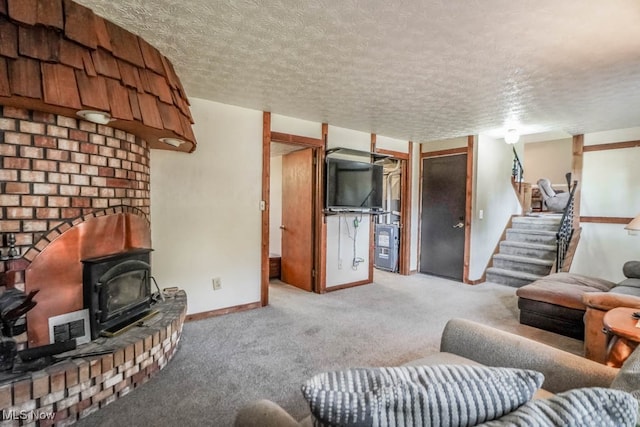 carpeted living room featuring a textured ceiling and a wood stove