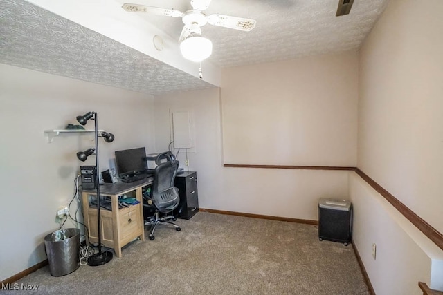 home office featuring light colored carpet, a textured ceiling, and ceiling fan