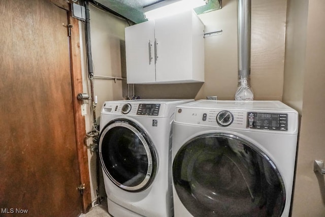 laundry area featuring cabinets and washer and clothes dryer