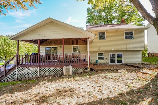 back of property with cooling unit and a deck