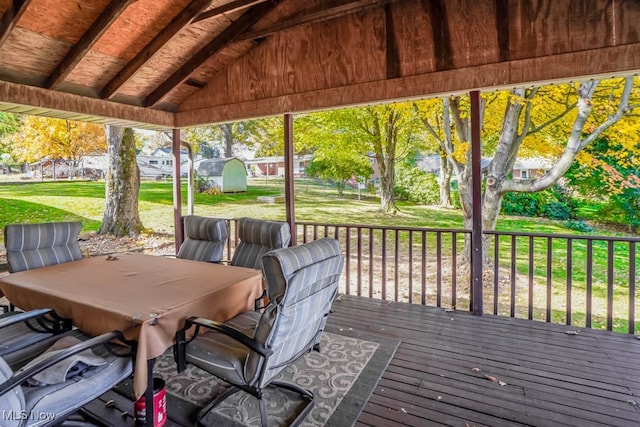 wooden terrace featuring a yard