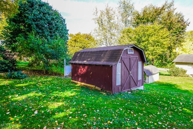 view of outbuilding featuring a yard