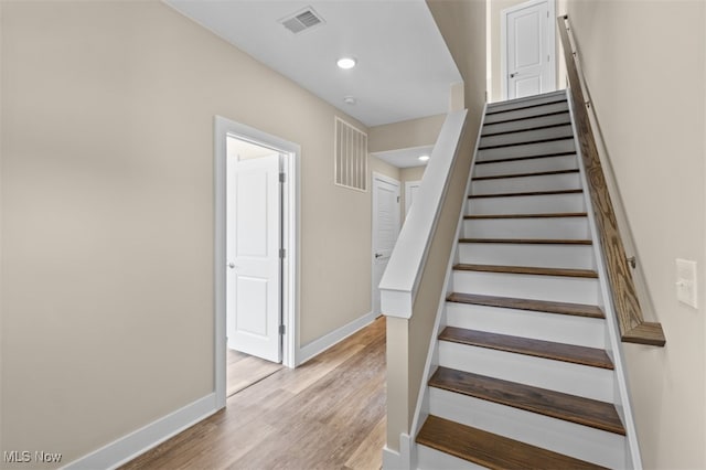 staircase featuring wood-type flooring