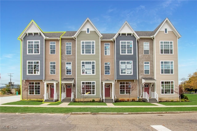 view of property featuring a front yard