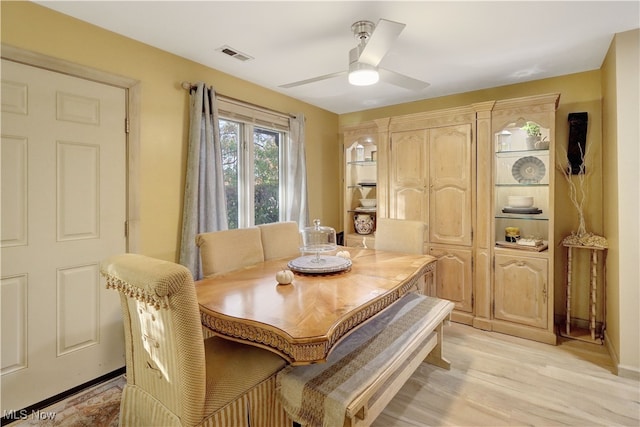 dining space featuring ceiling fan and light wood-type flooring